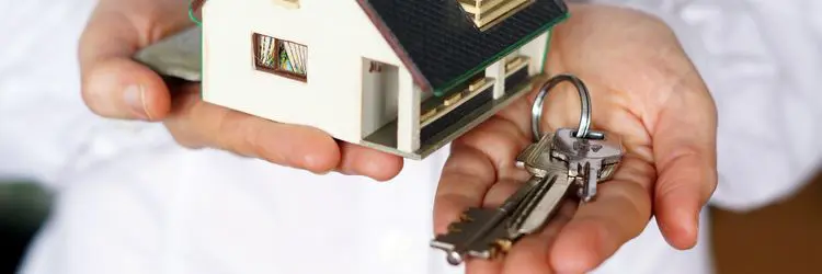 Property sales consultation with keys and handshake